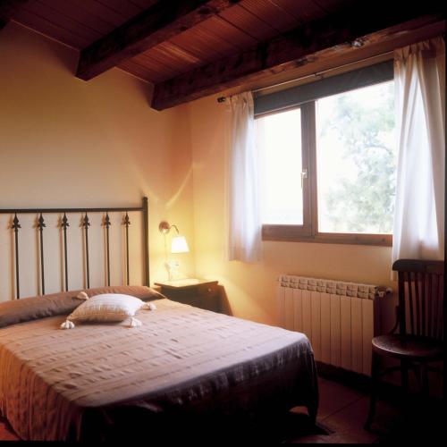 ein Schlafzimmer mit einem großen Bett und einem Fenster in der Unterkunft Torre Forcheron in Amposta