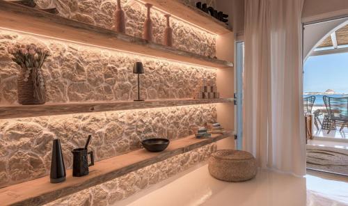 a kitchen with a stone wall and a window at Captain Zeppos in Pollonia