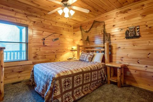 a bedroom with a bed in a log cabin at Hemlock Manor in Gatlinburg