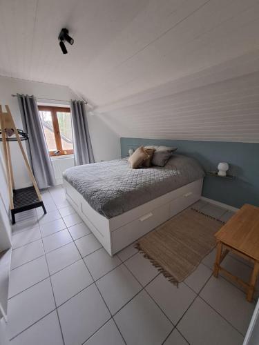 a bedroom with a bed and a tiled floor at Le Louis Vakantiehuis in Lanaken