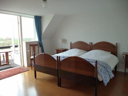 Ένα ή περισσότερα κρεβάτια σε δωμάτιο στο Aan Het Veer minimaal 4 overnachtingen