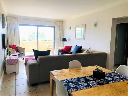 a living room with a couch and a table at Aquarella 1 in Plettenberg Bay