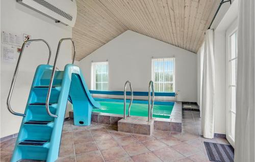 a playground with a blue slide in a room at Stunning Home In Skjern With Kitchen in Lem