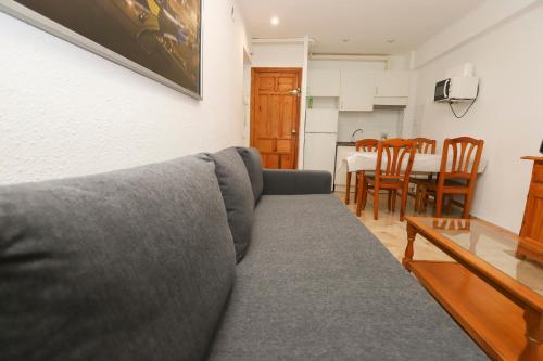 a living room with a gray couch and a table at DIFFERENTFLATS Acantilados in Salou