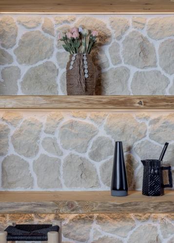 a shelf with a vase with flowers on it at Captain Zeppos in Pollonia