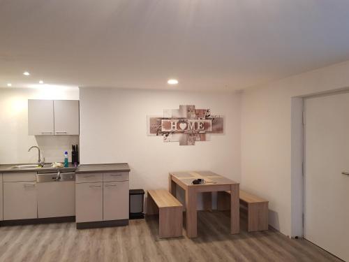 a kitchen with a counter and a table in a room at Lila Pause in Ellweiler