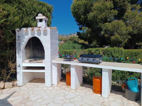 a white play house sitting on a patio at 1-Bed Apartment close to Moraira town centre in Moraira