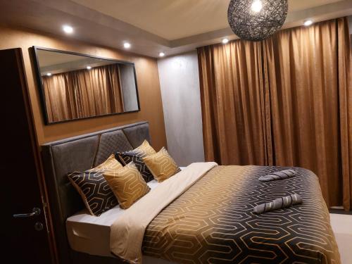 a bedroom with a bed with pillows and a mirror at Elite-stan na dan in Berane