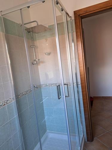 a shower with a glass door in a bathroom at Santa Teresa Gallura Green House in Santa Teresa Gallura