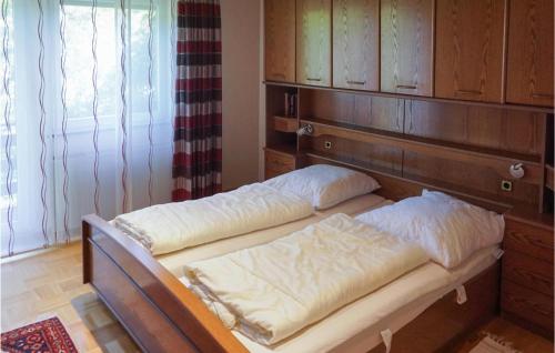 two beds in a room with a wooden headboard at Stunning Apartment In Hinterweidenthal in Hinterweidenthal