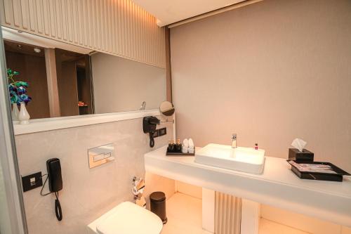 a bathroom with a sink and a mirror at Regenta Place Verka Amritsar in Amritsar