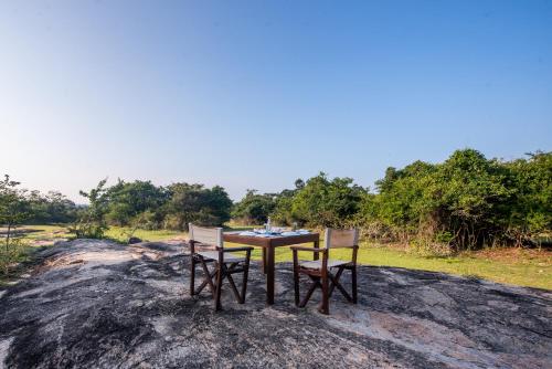 a table and two chairs sitting on top of a rock at Wild Trails Yala by Suri in Yala