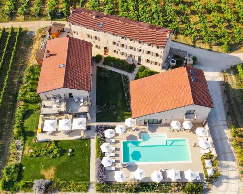 an aerial view of a house with a swimming pool at Magari Estates Boutique Hotel in Colognola ai Colli