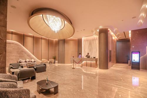a lobby of a hotel with a large chandelier at Regenta Place Verka Amritsar in Amritsar