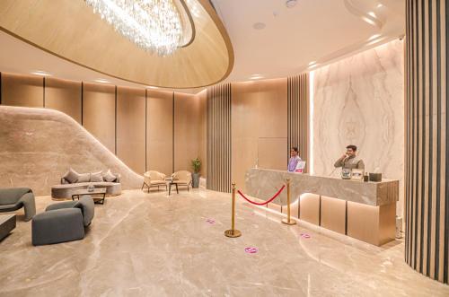 a lobby with a man standing at a counter at Regenta Place Verka Amritsar in Amritsar