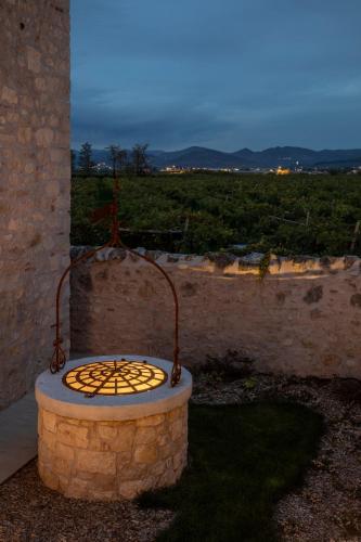 a fire pit sitting on the side of a building at Magari Estates Boutique Hotel in Colognola ai Colli