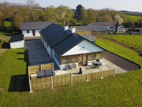 an overhead view of a house with a fence at Rose Cottage in Muff