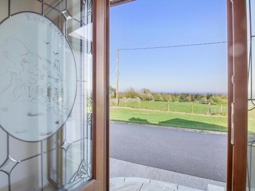 a glass door with a view of a road at Rose Cottage in Muff