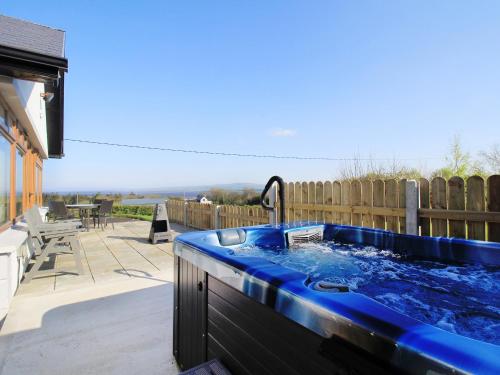 a hot tub in the backyard of a house at Rose Cottage in Muff