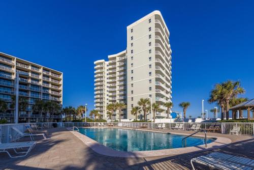a large apartment building with a swimming pool and a building at Seaside Beach & Racquet 2105 in Orange Beach