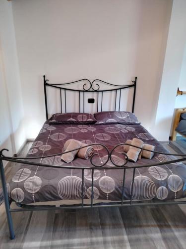 a bed with a metal frame with shoes on it at Agritur Lavanda in Nave San Rocco