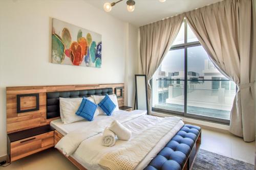 a bedroom with a large bed and a large window at Prime Views HH2422 in Dubai