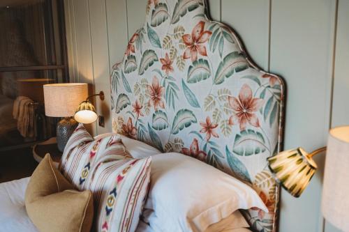 a bedroom with a large chair with a flower pattern at Finch's Arms in Oakham