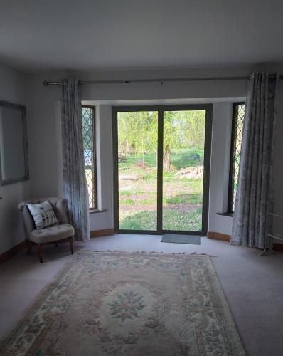 an empty living room with a large sliding glass door at The Wandering Donkey Guest House in Carlow