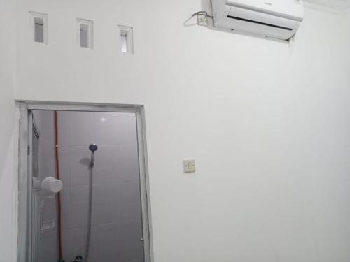 a bathroom with a shower stall and a window at KENARI P25 HOMESTAY in Purwokerto