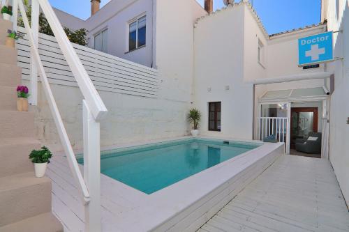 een zwembad in een gebouw met een trap en een huis bij Casa Jaume II 262 By Mallorca Charme in Muro