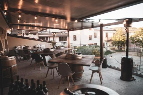 a restaurant with tables and chairs on a patio at Magari Estates Boutique Hotel in Colognola ai Colli