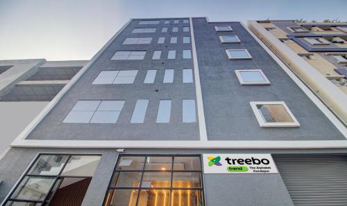 a tall building with a treeo sign on it at Treebo De Alphabet Kondapur in Hyderabad