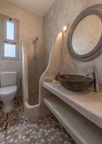 a bathroom with a sink and a toilet and a mirror at Happy Babi in Adamantas