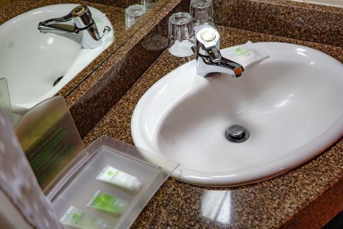 a bathroom counter with a sink and a white sink at Holiday Inn - Harare, an IHG Hotel in Harare