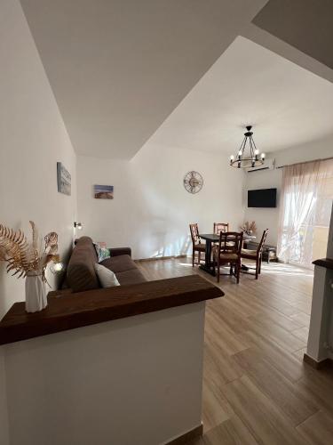 a living room with a couch and a table at Waikiki House in Passoscuro