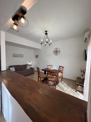 a dining room and living room with a table and chairs at Waikiki House in Passoscuro