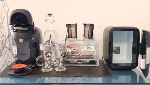 een aanrecht met een koffiezetapparaat en glazen erop bij Ambassador Guest House Bed and Breakfast in Paignton