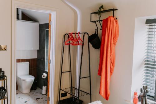 a bathroom with two towel racks and a toilet at 37 Jubilee Street in Llandudno