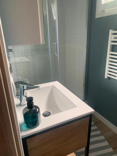 a white sink in a bathroom with a mirror at "D" Domki na wodzie Barczewko 4 z 4 domków in Barczewko
