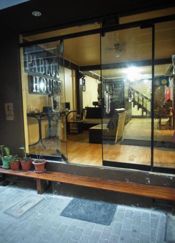 a store front window of a house with plants at Hostal Pablo's House in Machu Picchu