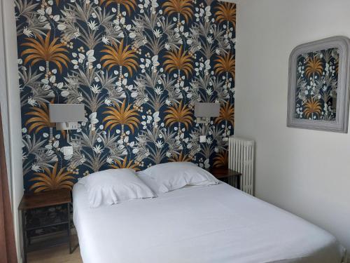 a bedroom with a blue and gold wallpaper and a bed at Le Royalty in Angers