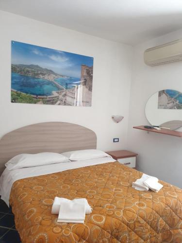 a bedroom with a large bed with towels on it at Hotel Mareluna Ischia in Ischia