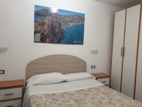 a bedroom with a bed and a picture on the wall at Hotel Mareluna Ischia in Ischia