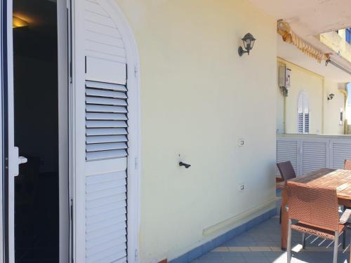 a door leading to a patio with a table at Hotel Mareluna Ischia in Ischia