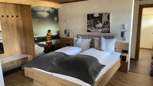 a bedroom with a large bed with a picture on the wall at Quartier Severin in Berwang
