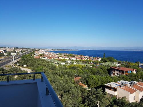 a view of the city and the ocean from the balcony of a house at Hotel Santana in Altınoluk