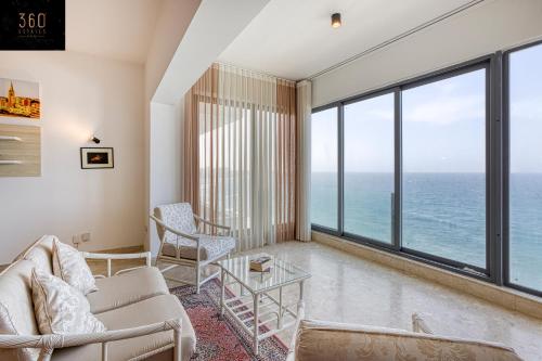a living room with a view of the ocean at Tower Road Sliema, 4BR APT with sensational views by 360 Estates in Sliema