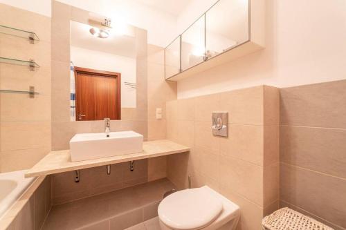 a bathroom with a white sink and a toilet at Duży Apartament w Helskiej Villi in Hel