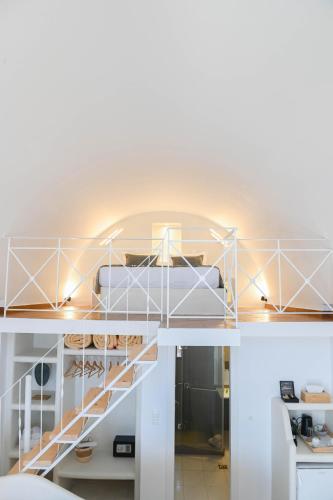 a room with a spiral staircase in a house at Amerisa Suites & Villa in Fira