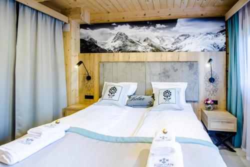 a bedroom with a large bed with a painting on the wall at Skansen Holiday in Cholerzyn